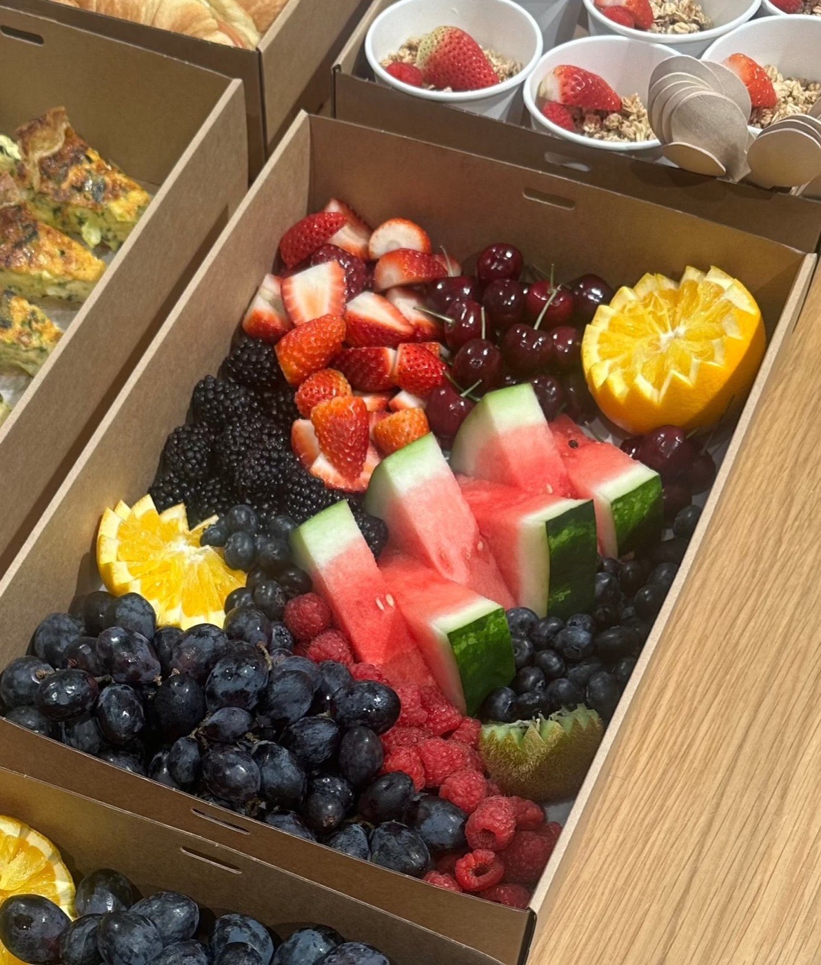 Fruit grazing box with watermelon, strawberries, berries, grapes and orange