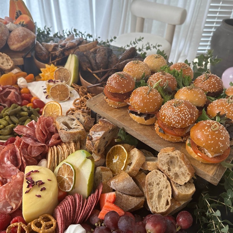 Grazing table with beef sliders, cheeses, cured meats and bread